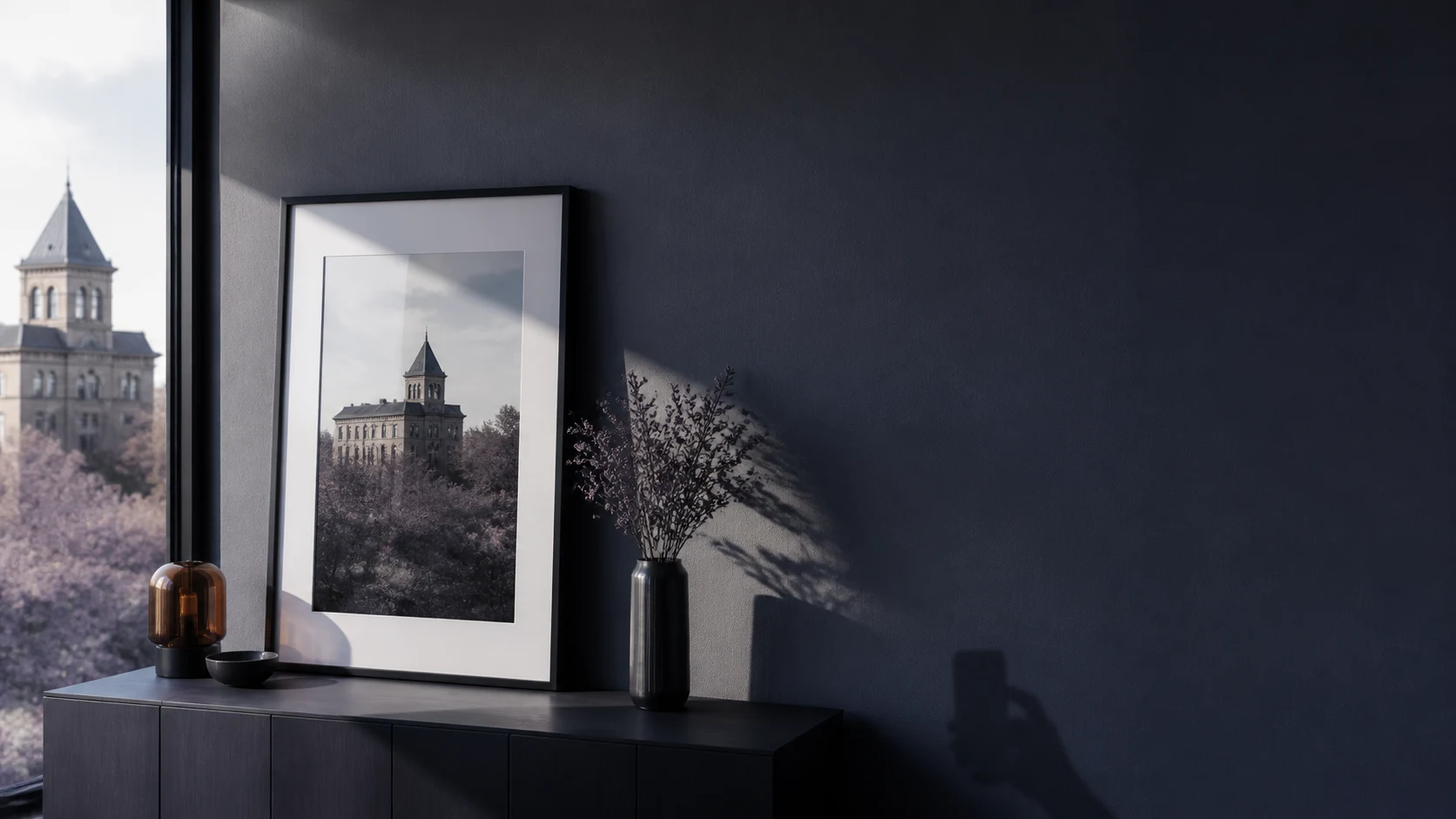 A framed reference photograph beside a window, evoking a return to the same composition